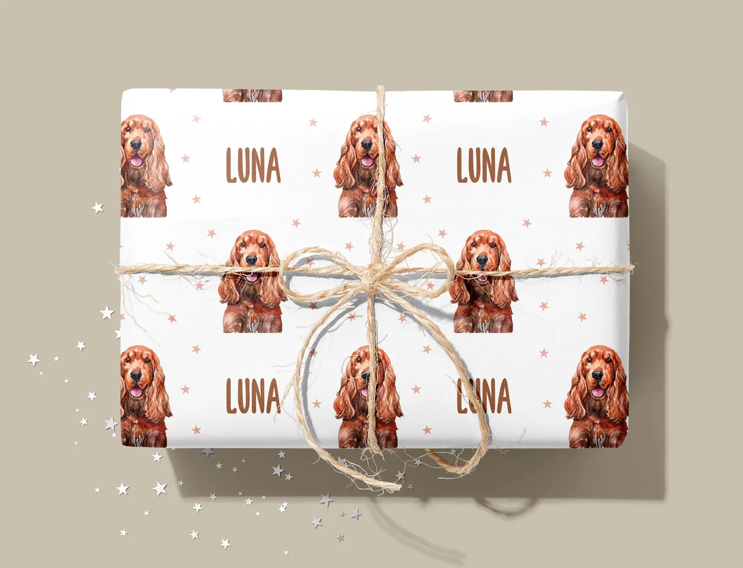 A present wrapped in paper printed with a cocker spaniel and its name, Luna